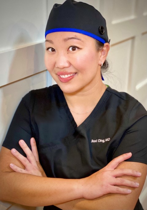 Dr. Jiaxi Ding in a surgical cap
